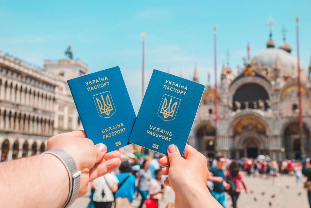 Hand,Holding,Ukrainian,Biometric,Passports,Travel,Concept,Freedom,Of,Movement © Shutterstock